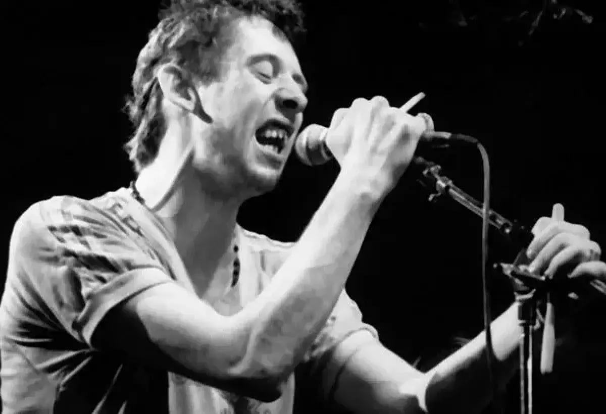 Shane MacGowan singing with intense expression