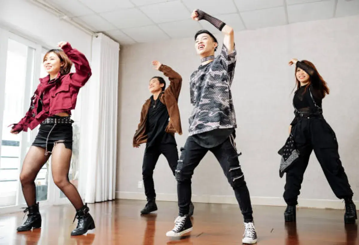  K-pop trainees rehearsing choreography in a studio mirror room