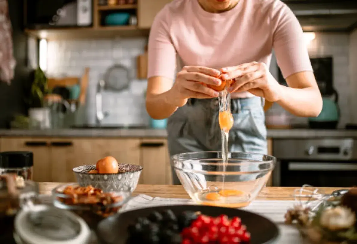 Fresh eggs being prepared for a baking recipe.