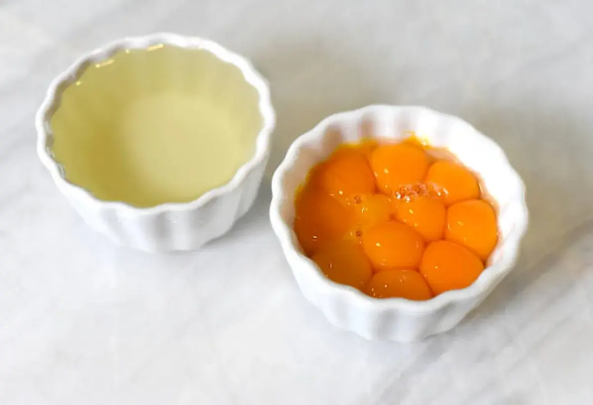 Egg yolks and whites separated for baking preparation.