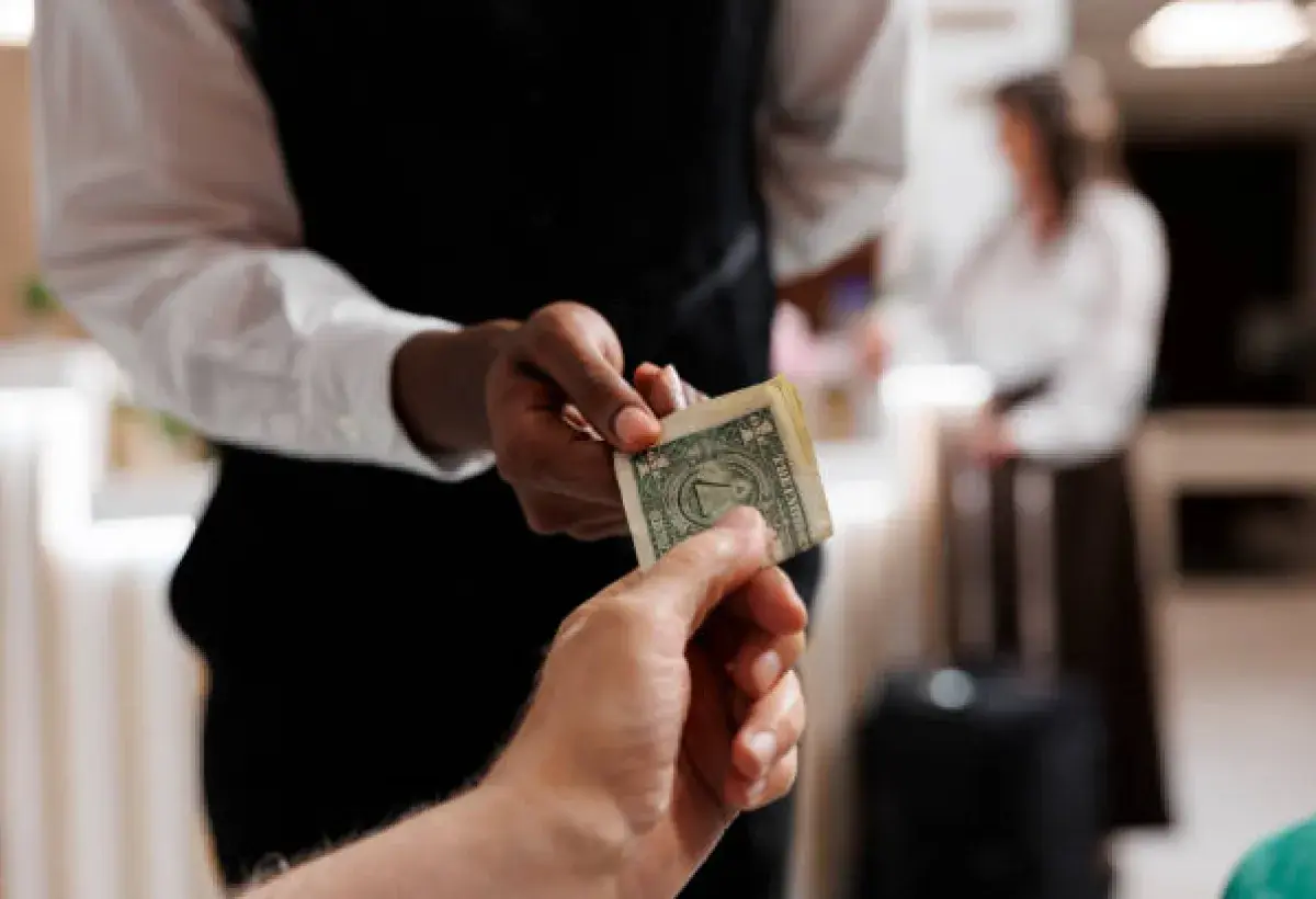 American hotel guest leaving a tip for housekeeping staff.