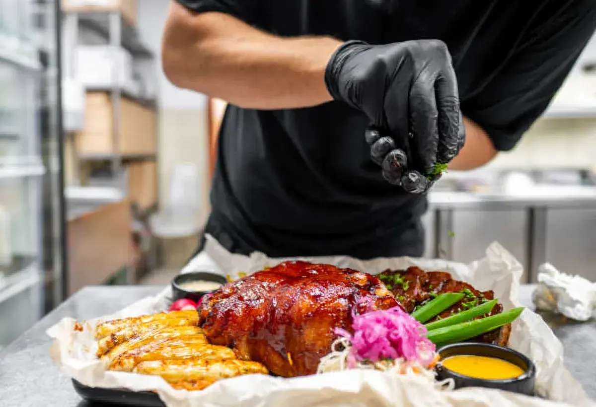 Chef arranging a very full American restaurant portion before serving