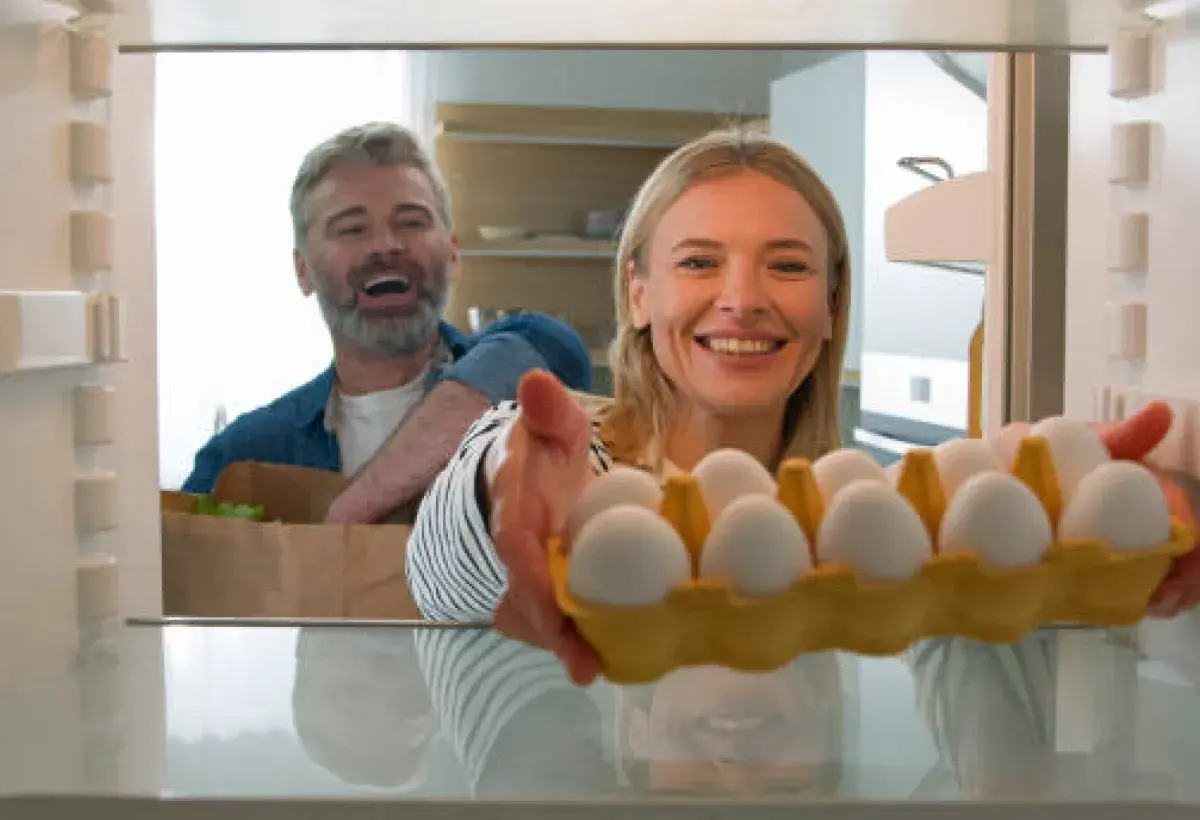 Family storing eggs in their home refrigerator in the United States