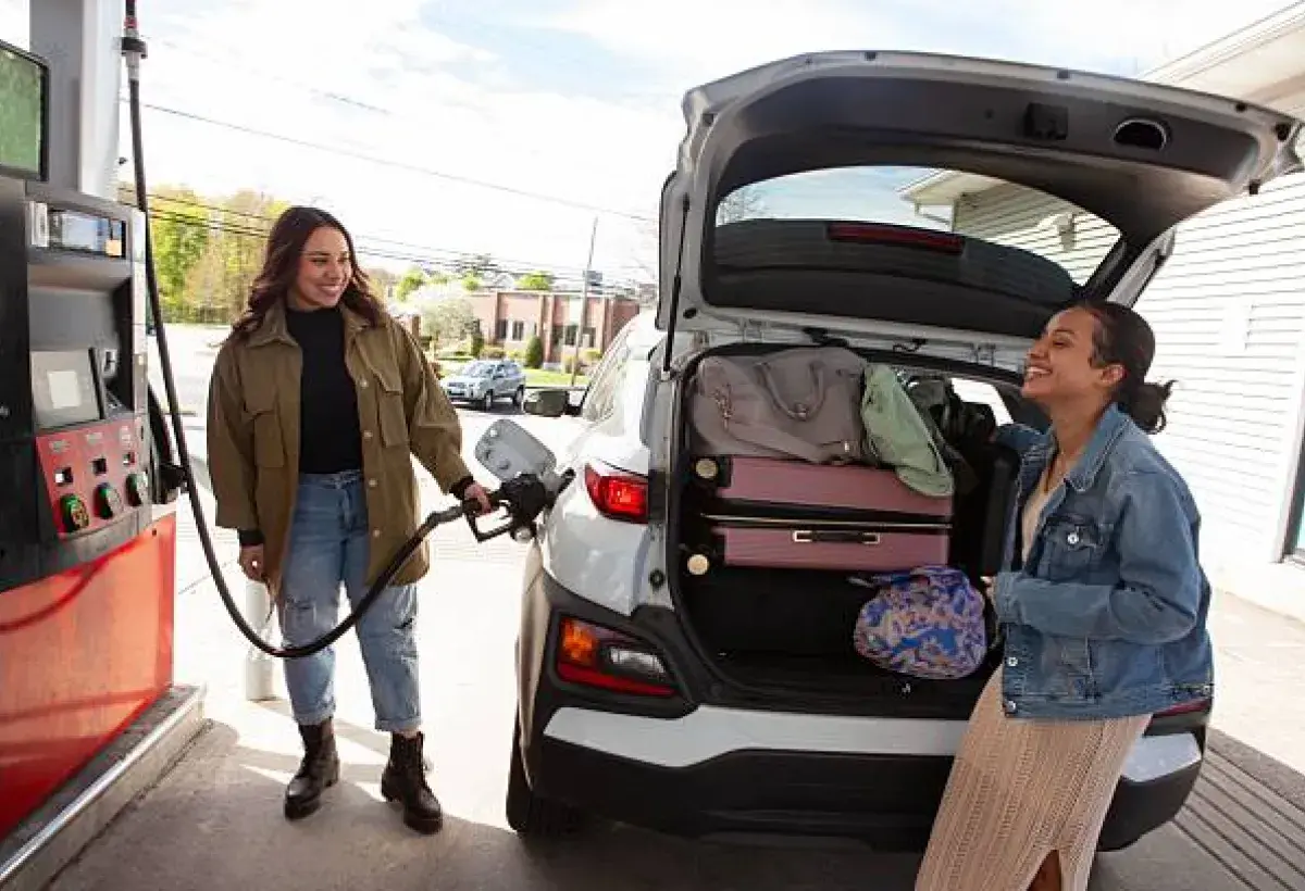 American family refueling their vehicle amid changing gas prices.