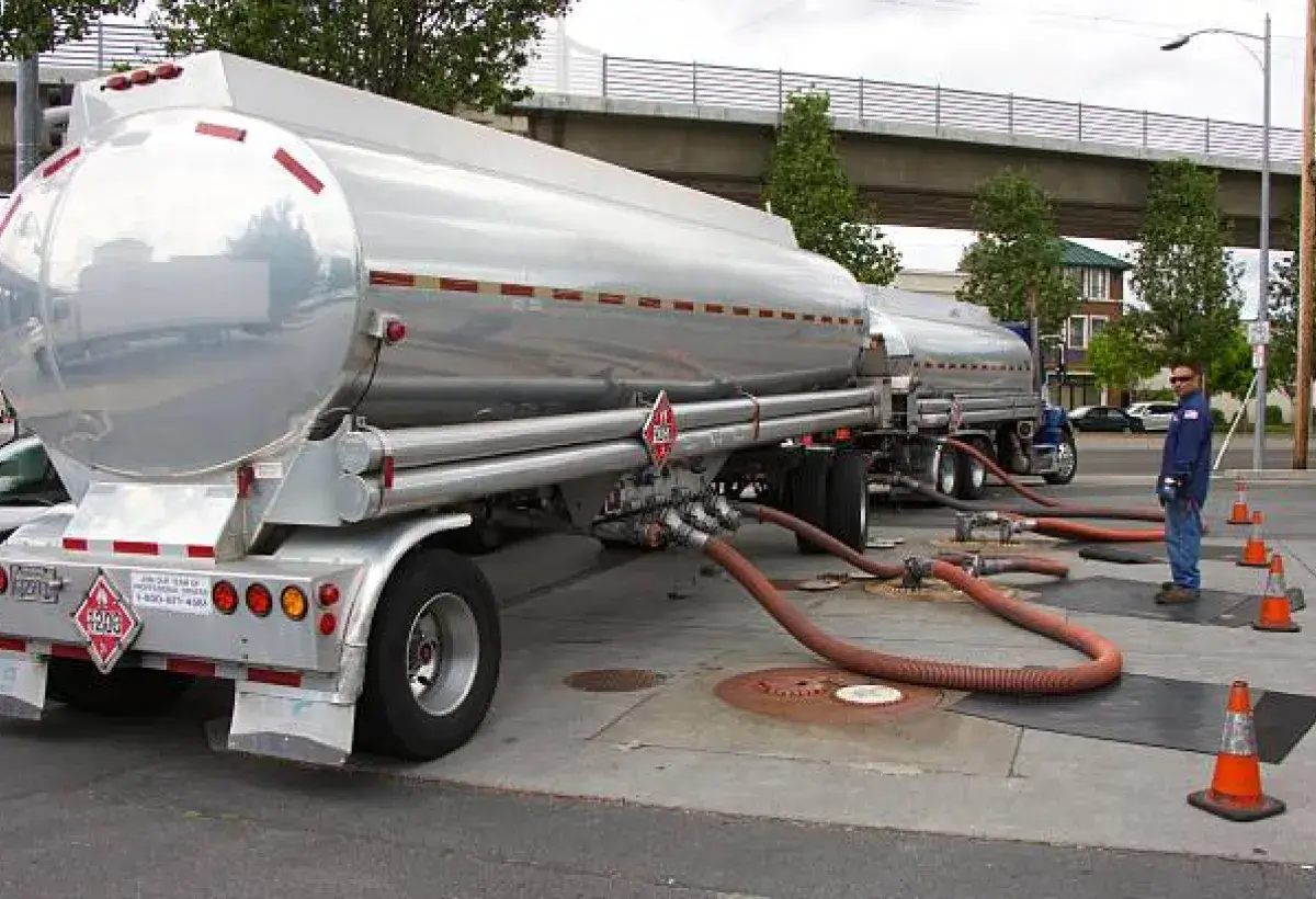 Fuel tanker trucks delivering gasoline to distribution terminals.