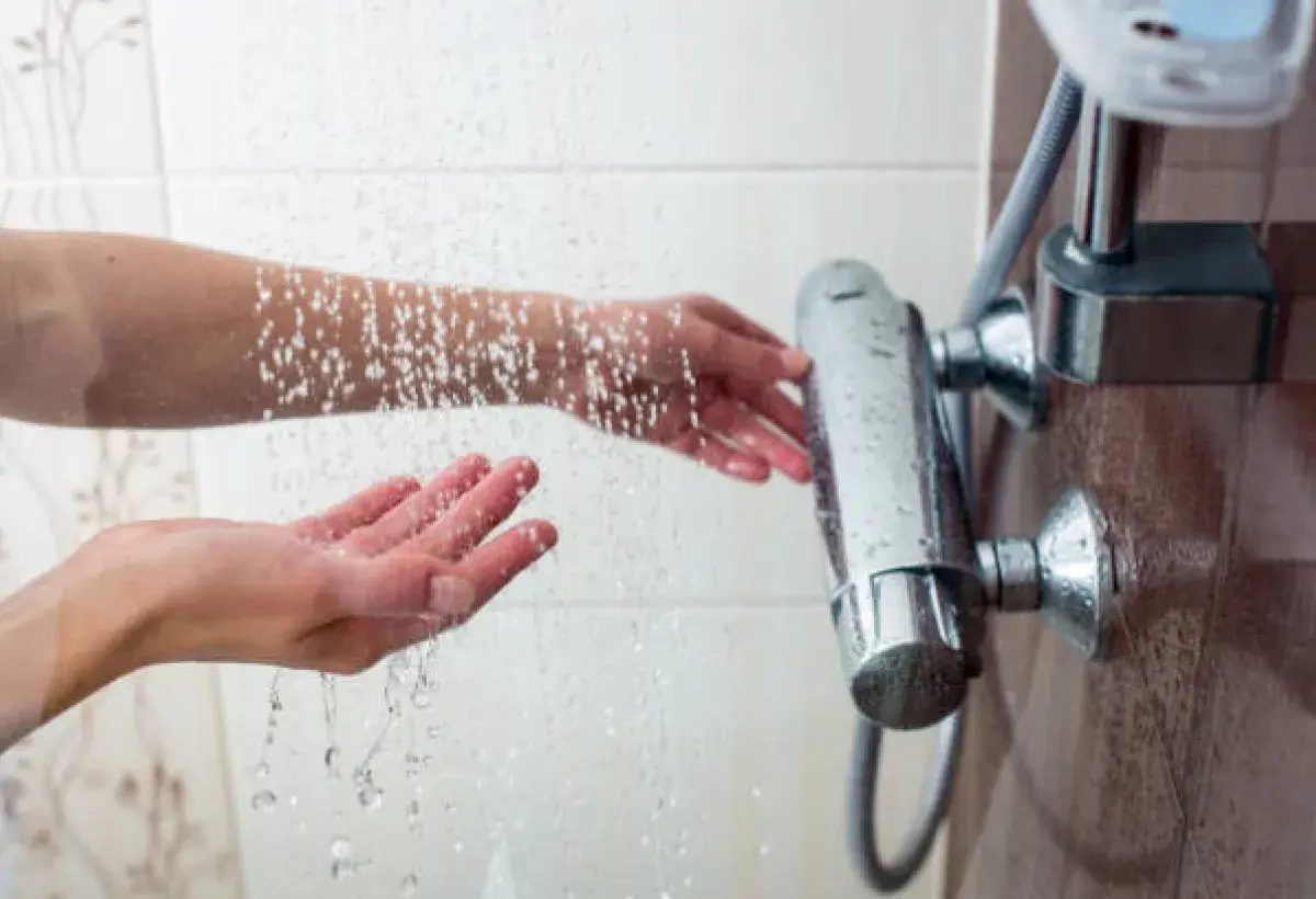 Adjusting water temperature in a warm steamy bathroom