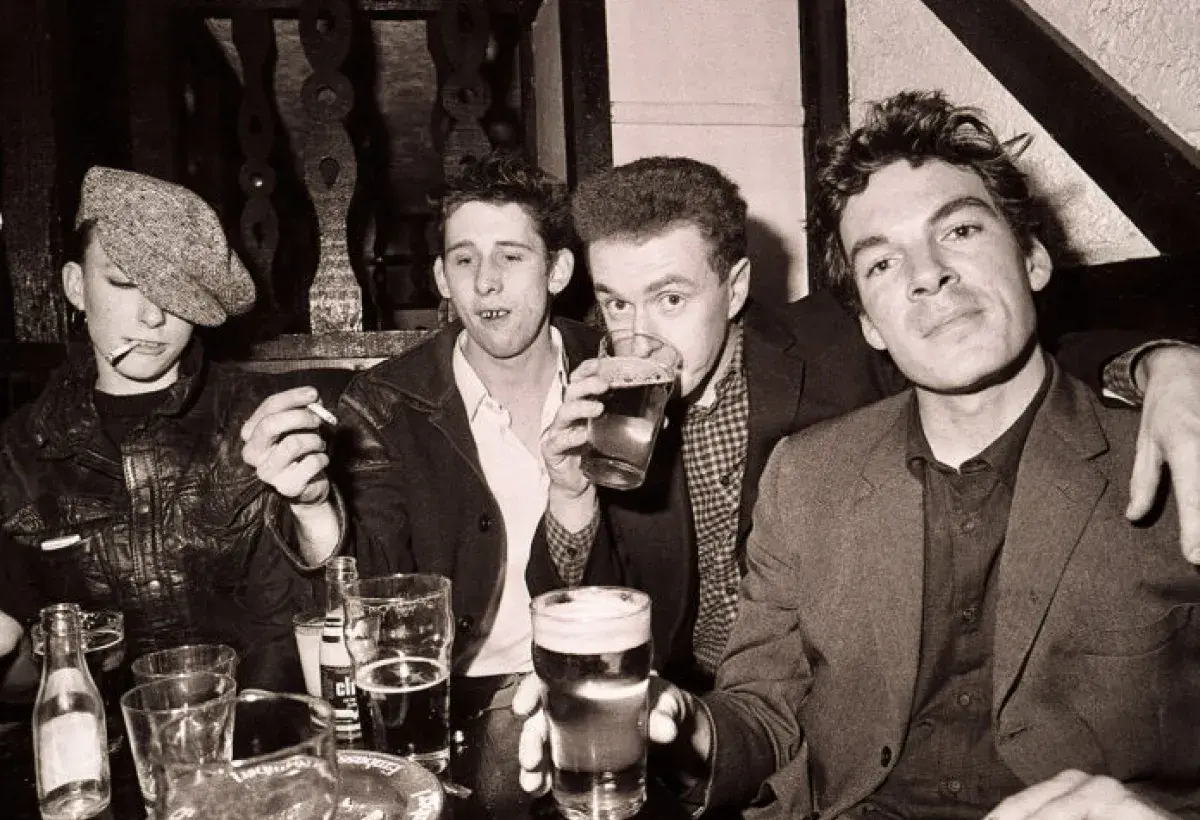 Early era photo of The Pogues in a raw and energetic setting