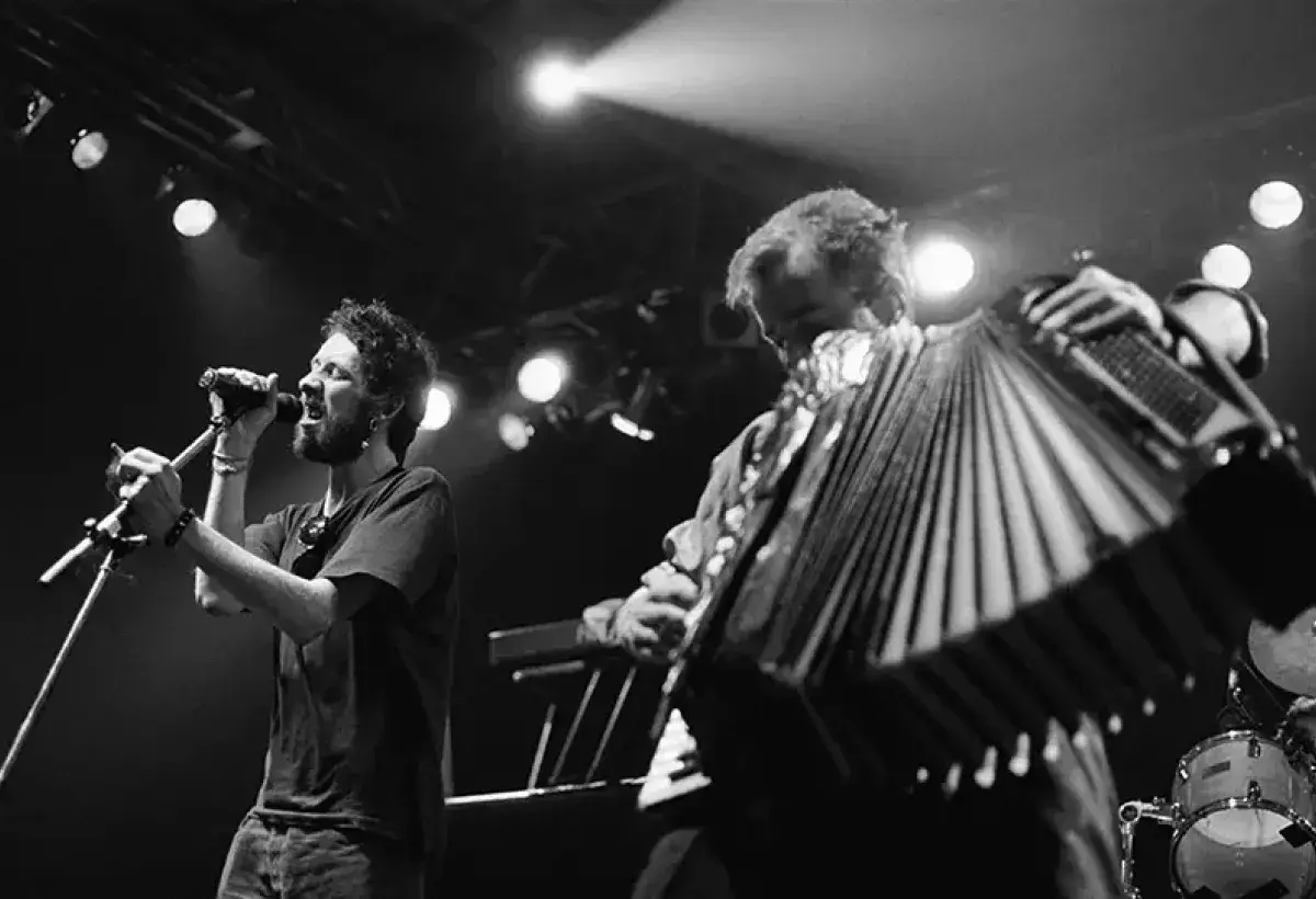 Tin whistle and accordion illuminated on stage