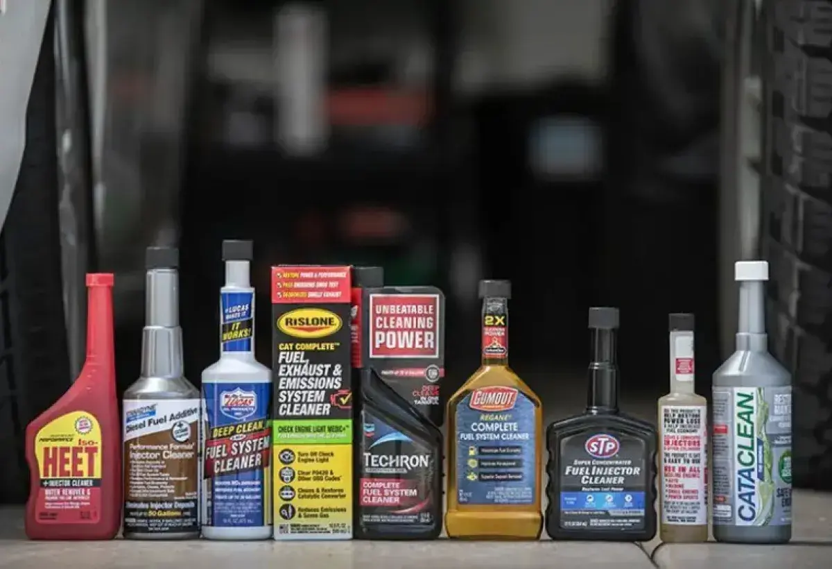Fuel additive product on a table with a car behind
