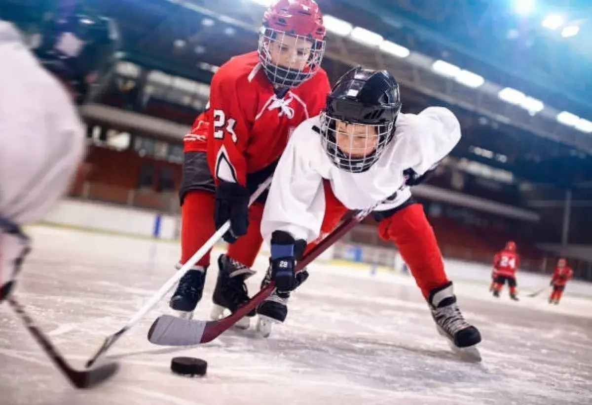 Ice hockey forward firing shot toward goal during professional hockey game