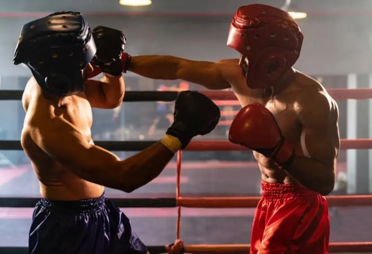 Professional boxers exchanging punches inside boxing ring before roaring crowd