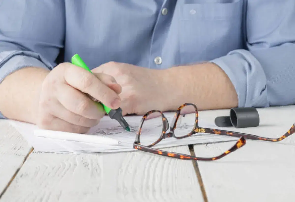 Teacher using non red ink to grade student work