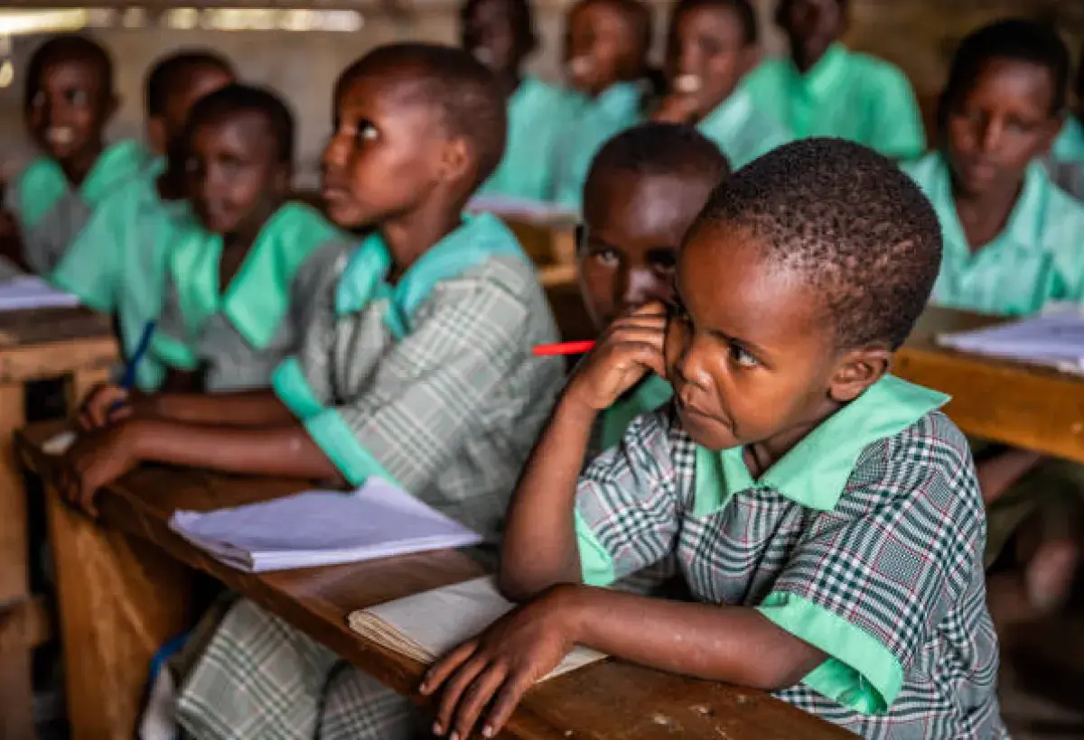 Nigerian students practicing formal classroom behavior