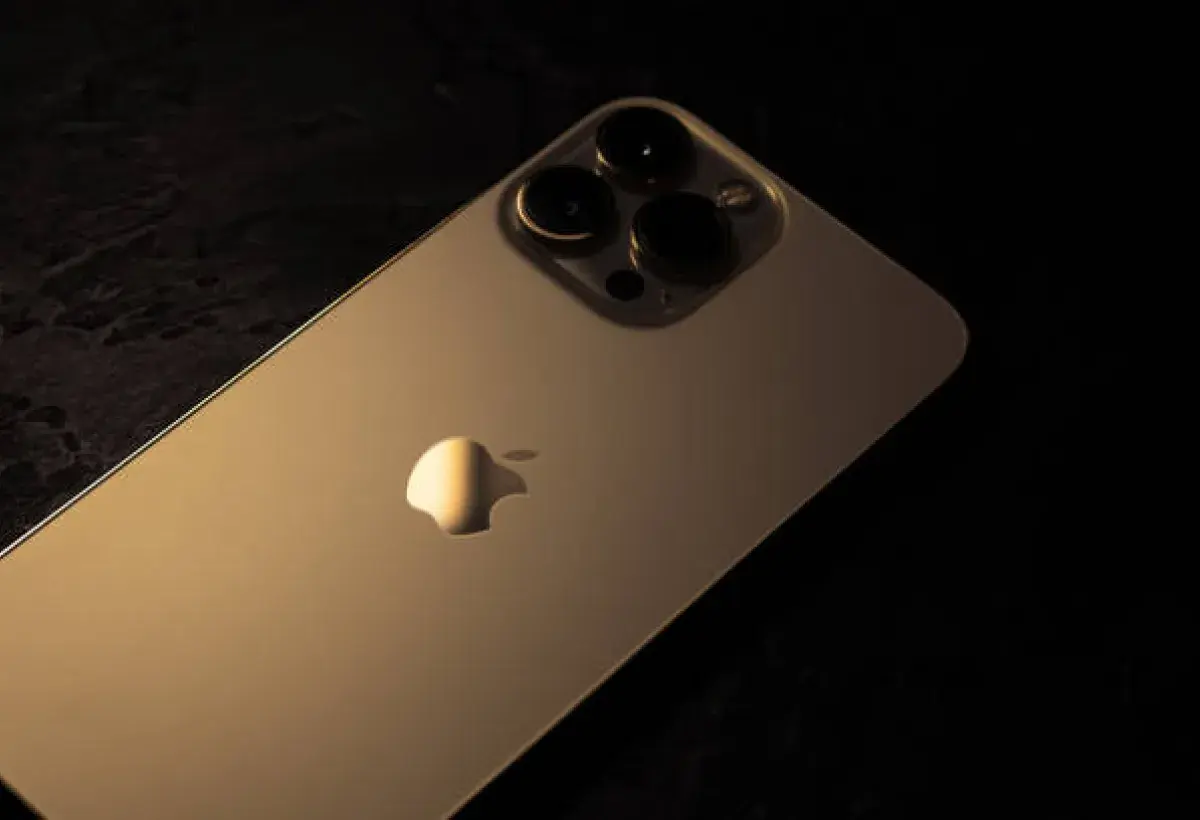 Gold iPhone shining under soft light