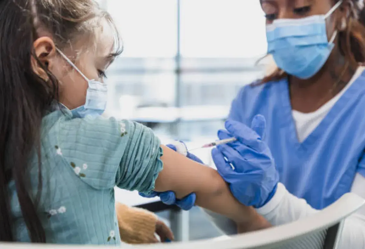 Healthcare workers administering vaccines in a community clinic