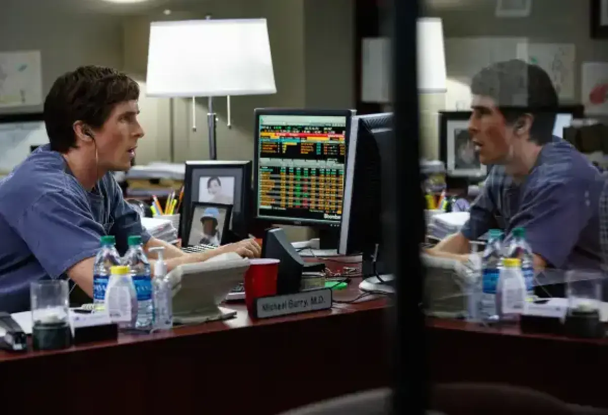 Christian Bale explaining financial charts to the camera