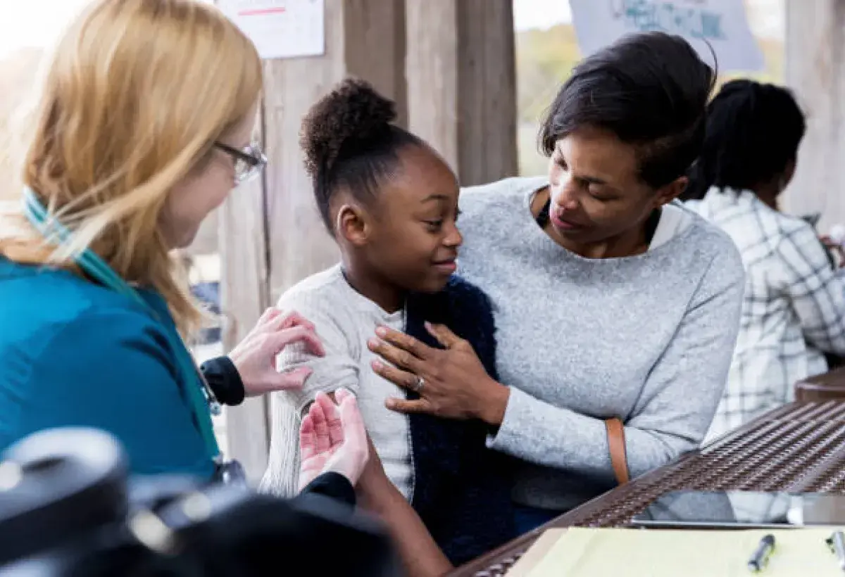 Child receiving recommended vaccines safely
