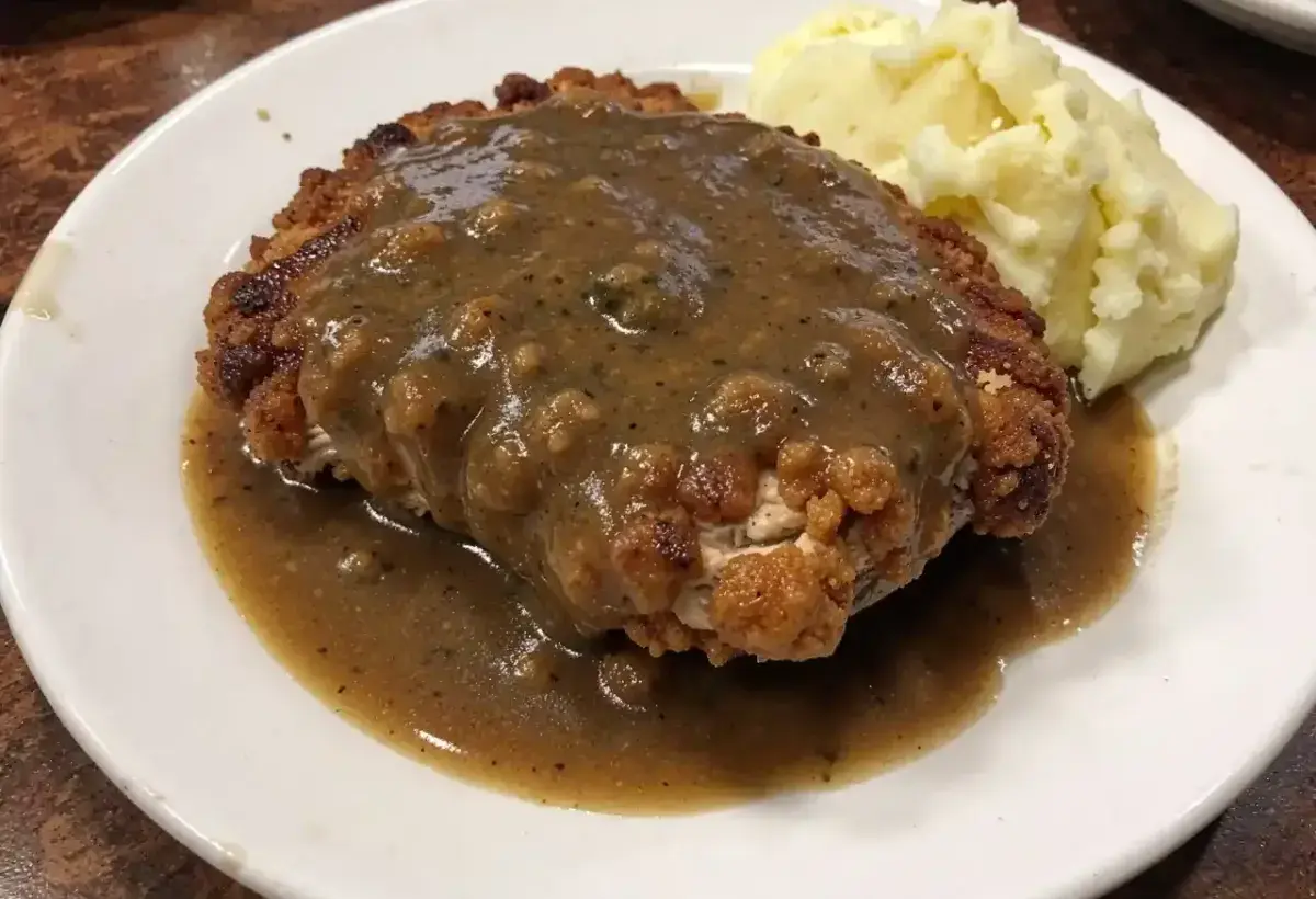Chicken fried steak with creamy gravy and sides