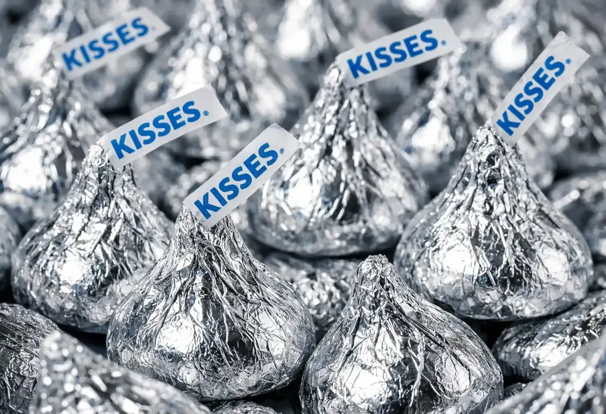 Hershey Kisses wrapped in foil with paper plumes