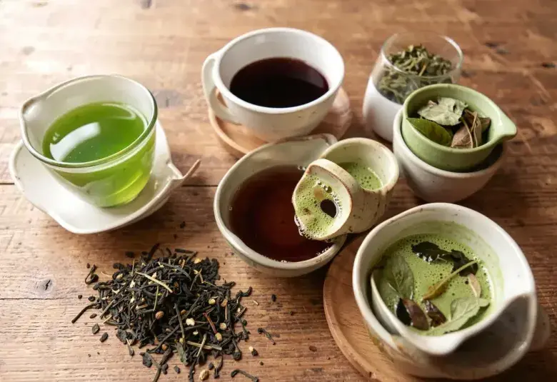 Assorted tea varieties including green tea black tea matcha and herbal tea in cups