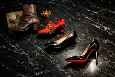 A timeline of heel styles from a sturdy cavalry boot to a sleek red-soled stiletto, symbolizing the rich history and evolution of high heels.