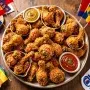 Variety of global fried chicken styles on a platter representing international competition